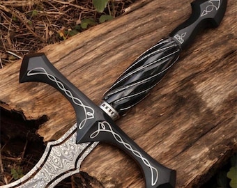 May include: A sword featuring a patterned Damascus steel blade and a black handle with a twisted grip. The crossguard and pommel are black with silver-colored filigree line detailing. The handle includes a silver-colored ring near the crossguard.
