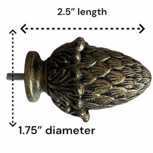 May include: A bronze-toned metal cabinet knob shaped like a pinecone with a textured, layered surface. The knob features a threaded screw attachment on the back. Text on the image indicates a length of 2.5 inches and a diameter of 1.75 inches.