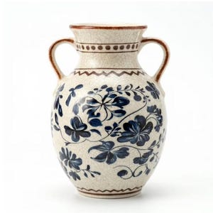 May include: A ceramic vase with two handles, featuring a cream-colored base with a fine crackle glaze finish. The surface is decorated with dark blue floral patterns, a brown zigzag band, and a dotted line around the neck and rim.