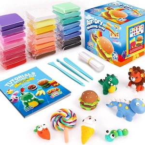 May include: An air-dry modeling clay kit featuring 24 individually wrapped colored clay blocks, a box with product text, three blue plastic sculpting tools, a tutorial booklet, and several small clay figures including a burger, dinosaur, and lion.