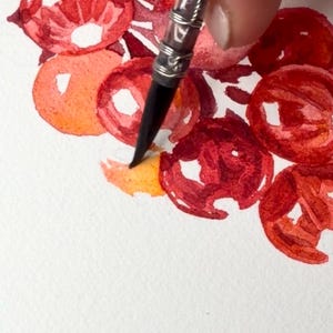 Close-up of the watercolor painting process while creating the original red currant botanical illustration. A paintbrush applies transparent watercolor layers to individual berries, building luminous colour, depth and highlights. The image shows the careful craftsmanship behind the artwork and the delicate glazing technique used to achieve a realistic botanical painting inspired by fruit from my own garden.
