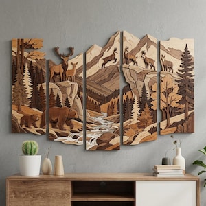 May include: A five-panel wooden wall art piece featuring a layered mountain landscape with a river, pine trees, a bear, a deer, and mountain goats. The artwork uses various shades of natural wood tones to create depth and texture across the panels.