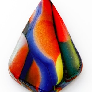 May include: A teardrop-shaped glass cabochon featuring a vibrant, multi-colored swirl pattern. The surface displays bold streaks of bright red, deep blue, warm orange, and hints of yellow and green, blended together in a smooth, polished finish.