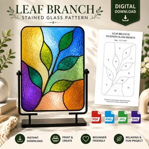 May include: A digital download for a leaf branch stained glass pattern. The image shows a finished stained glass panel with yellow, blue, green, purple, and orange glass pieces in a black metal stand, alongside a printed guide with a 5.5" by 8.6" size.
