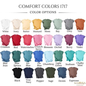 May include: A color chart for Comfort Colors 1717 t-shirts, displaying thirty-two short-sleeve shirts in various shades including white, ivory, butter, mustard, moss, bay, grey, yam, crimson, red, watermelon, crunchberry, blossom, orchid, berry, violet, blue jean, blue spruce, ice blue, flo blue, chambray, light green, seafoam, chalky mint, black, true navy, pepper, sage, denim, and espresso.