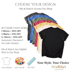 May include: A stack of six short-sleeved t-shirts in black, cream, yellow, red, green, and blue, arranged in a cascading vertical row. The image includes text: CHOOSE YOUR DESIGN, BUY MORE SAVE MORE, 2 Shirts = 10% OFF, 3 Shirts = 15% OFF, 5+ Shirts = 20% OFF.