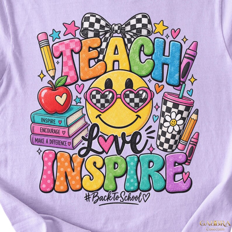 May include: A light purple t-shirt featuring a colorful graphic with the text TEACH, LOVE, INSPIRE, and #BackToSchool. The design includes a yellow smiley face with checkered heart sunglasses, a stack of books, an apple, a bow, and crayons.