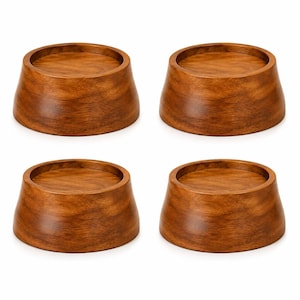 May include: A set of four circular wooden risers, each featuring a smooth, polished medium-brown finish with visible wood grain patterns. These objects have a tapered, truncated cone shape with a flat, recessed circular top surface.