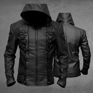 May include: A black hooded jacket featuring a central zipper closure, long sleeves, and decorative black lace-up detailing on the front panels and outer arms. The jacket includes ribbed shoulder panels and a hood, presented in both front and back views.