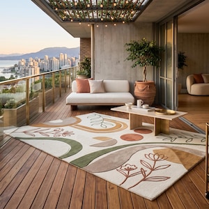 May include: A rectangular area rug featuring an off-white base with abstract shapes in shades of sage green, terracotta, and tan. The design includes stylized floral and leaf motifs, curved arches, and circular elements with a textured, tufted finish.