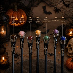 May include: Seven wands with black shafts and silver-toned claw-shaped tops holding spherical gemstones. The stones are labeled as Tiger Eye Stone, Rose Quartz, Red Agate, Yellow Jade, Green Aventurine, Amethyst, and Lapis Lazuli.
