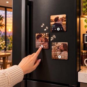 May include: Three square refrigerator magnets featuring custom photo prints designed to look like music player interfaces. Each magnet displays a song title, artist name, playback controls, and a heart icon, accompanied by white musical note icons.