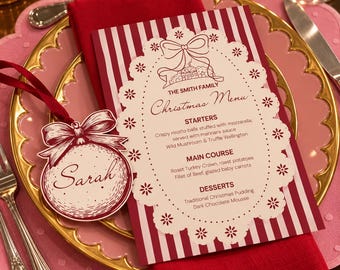 May include: A rectangular Christmas menu card with red and white vertical stripes, featuring a white die-cut lace border and a matching round name tag labeled Sarah. The menu lists starters, main course, and desserts for The Smith Family.