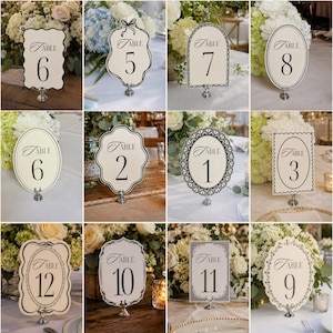 Peut inclure: Ensemble de cartons de numéros de table ivoire avec une écriture noire et des bordures décoratives. Chaque carton affiche un numéro de 1 à 12, monté sur un support argenté. Idéal pour les mariages ou événements.