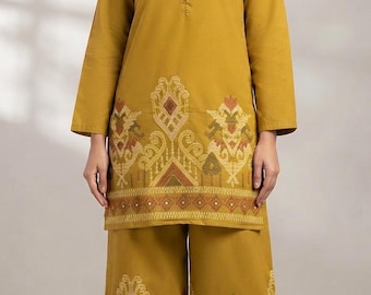 May include: A mustard yellow tunic and wide-leg trousers set featuring a mandarin collar, a button-down placket, and long sleeves. The hem of the tunic and the lower portion of the trousers are decorated with intricate geometric patterns in brown, cream, and red.