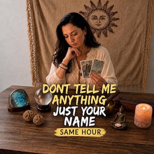 May include: A person holding two tarot cards at a wooden table with a blue labradorite stone, a crystal ball, two woven spheres, a small Buddha statue, and a lit candle. The text reads: DONT TELL ME ANYTHING JUST YOUR NAME SAME HOUR.