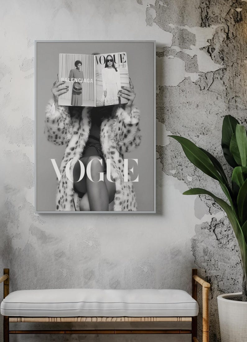 May include: A framed black and white wall art print featuring a person wearing a spotted faux fur coat, holding an open Vogue magazine in front of their face. The magazine displays the text Balenciaga and Vogue. The word VOGUE is printed in large white letters across the lower portion of the artwork.