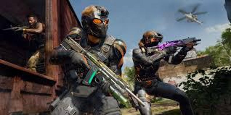 May include: A group of armed figures in tactical gear, holding rifles, are positioned in a combat scene. One figure is in the foreground, wearing a helmet and holding a rifle with a green magazine. A helicopter flies in the background.