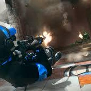 May include: A person in a black and blue tactical suit, helmet, and gloves, aiming a rifle. The scene is a war zone with explosions and other soldiers in the background. The game title "Call of Duty Warzone" is visible.