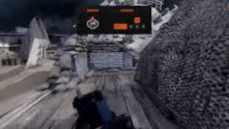 May include: A first-person perspective from a video game, showing a player moving through a war-torn environment. The scene includes wooden walkways, concrete structures, and a camouflage net. An orange and black heads-up display is visible.