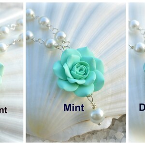 May include: Three pearl necklaces with a single mint green flower pendant. The flower pendants are in three shades of mint green: light mint, mint, and dusty mint.