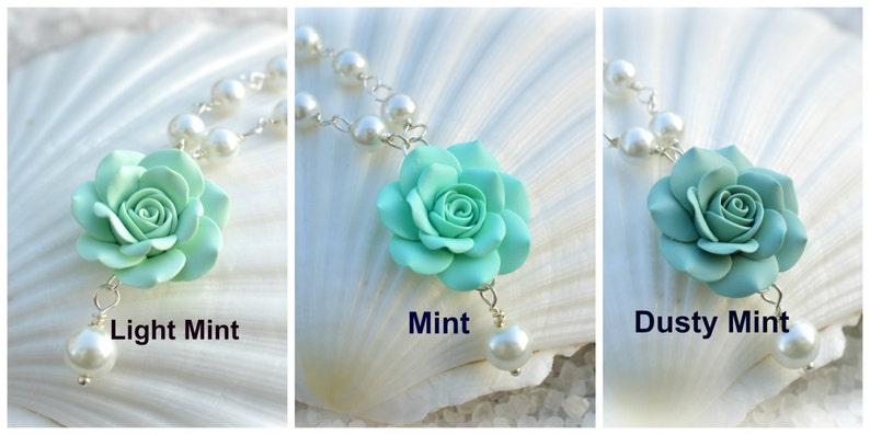 May include: Three pearl necklaces with a single mint green flower pendant. The flower pendants are in three shades of mint green: light mint, mint, and dusty mint.