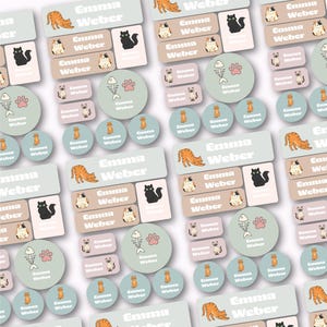 May include: A collection of rectangular and circular adhesive labels in shades of light green, beige, and pink. Each label features the name Emma Weber in white text, accompanied by illustrations of various cats, fish skeletons, and paw prints.