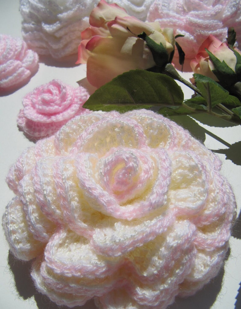 May include: A set of crocheted roses in white and pink. The roses are made with a delicate, lacy stitch and are perfect for adding a touch of elegance to any home decor.