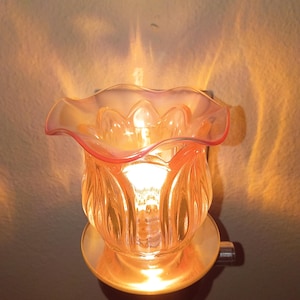 Pink glass fragrance oil diffuser aroma lamp with dimmer switch.