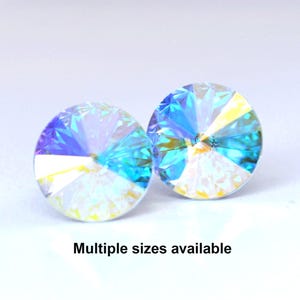 May include: Two iridescent blue round crystal rhinestones with a faceted design.
