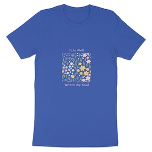 Op de afbeelding: Een koningsblauw t-shirt met korte mouwen en een centrale vierkante afbeelding van kleine roze, gele en witte bloemen met groene stengels. De tekst "It Is Well" staat boven het bloemenvierkant en "Within My Soul" staat eronder.