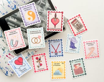 Puede incluir: Una colección de pegatinas rectangulares con forma de sello postal que incluyen varias ilustraciones y textos, como Opposites Attract, Enemies to Lovers, Marriage of Convenience, Hockey, Cowboy, Friends to Lovers, Second Chance, Fantasy, Grumpy Sunshine y One Bed.