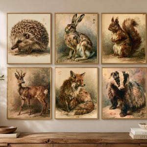 May include: A set of six square wall art prints featuring watercolour-style illustrations of woodland animals including a hedgehog, a hare, a squirrel, a deer, a fox, and a badger, all displayed in a grid arrangement with light-coloured wooden frames.