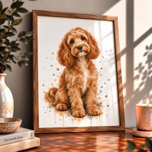 May include: A framed wall art print featuring a watercolour-style illustration of a fluffy golden-brown dog sitting upright. The dog has long, wavy ears and a white chest patch, set against a white background with scattered brown and tan dots.