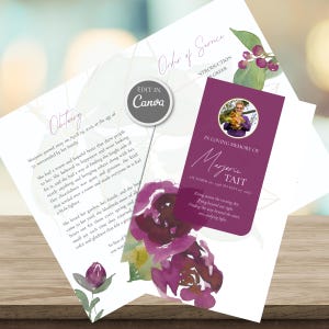 May include: A funeral programme template featuring a white background with watercolour purple floral accents. The design includes an obituary section, an order of service, and a memorial card with a circular photo of a person and the text Marjorie Tait.