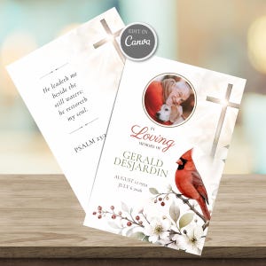 May include: A funeral program card featuring a circular photo of a person with a dog, a red cardinal bird on a branch with white flowers, a cross, and the text In Loving Memory of Gerald Desjardin, August 12 1954, July 6 2026, and Psalm 23:2.