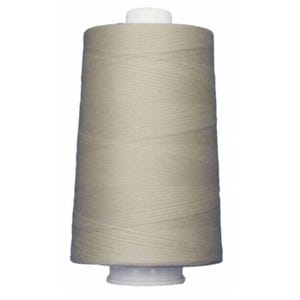 May include: A spool of beige thread for sewing or embroidery.