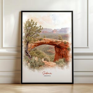 May include: A framed watercolour print depicting the red rock landscape of Sedona, Arizona, featuring a natural stone arch, a prominent tree, and prickly pear cacti in the foreground, with the text Sedona ARIZONA printed at the bottom.