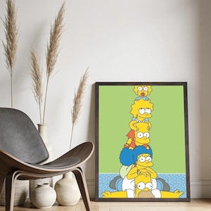 May include: A framed vertical wall art print featuring a stack of five yellow cartoon characters from The Simpsons, including Homer, Marge, Bart, Lisa, and Maggie, set against a light green background with a blue patterned base inside a dark frame.