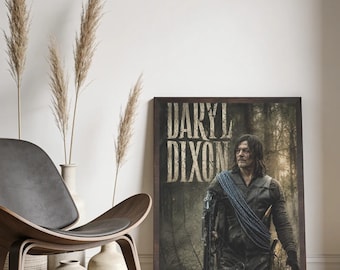 May include: A rectangular framed poster featuring a portrait of Daryl Dixon in a dark forest setting. The character wears a dark vest and carries a crossbow with blue rope draped over the shoulder. The text DARYL DIXON appears in large letters.