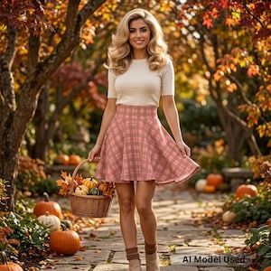 May include: A short-sleeved cream-colored top paired with a pink and brown plaid skirt. The skirt features a high-waisted design with a flared silhouette. A woven wicker basket filled with small pumpkins is held in one hand.