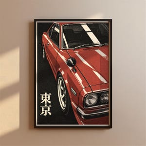 May include: A framed poster featuring a red vintage sports car viewed from a high angle. The car has round headlights, a chrome bumper, and a fender-mounted side mirror. The Japanese characters for Tokyo are printed in white on the left.