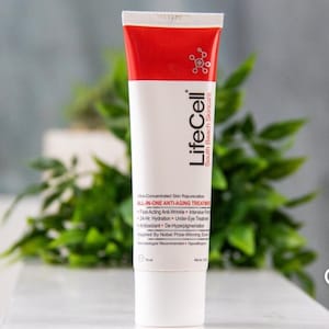 May include: A white and red tube of LifeCell South Beach Skincare anti-aging treatment. The tube features the brand name and product information, including "ALL-IN-ONE ANTI-AGING TREATMENT." The background includes green foliage.