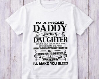 May include: White t-shirt with black text that reads "I'M A PROUD DADDY of a PRETTY DAUGHTER." The text continues with humorous statements about a daughter. A great gift for a father.