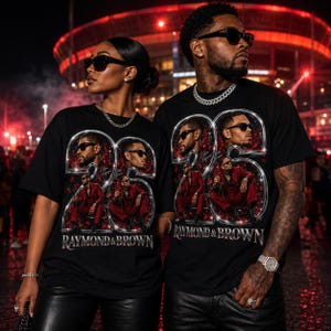 May include: A black short-sleeve t-shirt featuring a large graphic print of the number 25 in a metallic chrome finish. The design includes multiple photographic images of a person in a red suit, red roses, and the text RAYMOND & BROWN.