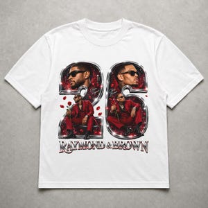 May include: A white t-shirt featuring a graphic print of the number 26 in a metallic chrome finish. Inside the numbers are portraits of two men in red suits holding red roses. The text "RAYMOND & BROWN" appears in metallic chrome lettering below.