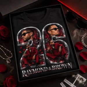 May include: A black t-shirt featuring a large graphic of the number 25 in a metallic silver frame. Inside the numbers are portraits of two men in red suits, with the text "Usher Raymond" and "Chris Brown" and "RAYMOND & BROWN" printed below.