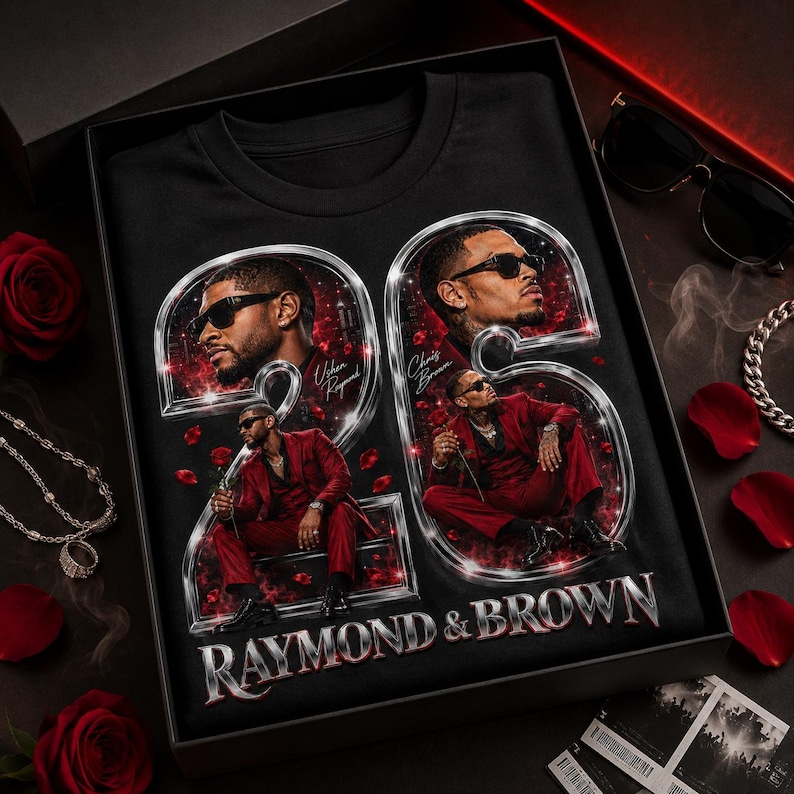 May include: A black t-shirt featuring a large graphic of the number 25 in a metallic silver frame. Inside the numbers are portraits of two men in red suits, with the text "Usher Raymond" and "Chris Brown" and "RAYMOND & BROWN" printed below.