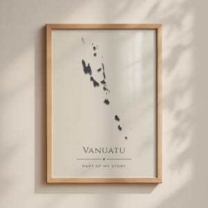 May include: A framed wall art print featuring a black silhouette map of the islands of Vanuatu centered on a light beige background. Below the map, the text reads VANUATU in capital letters, followed by a small diamond icon and PART OF MY STORY.