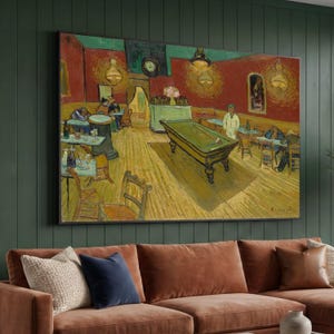 May include: A framed print of Vincent van Gogh's "The Night Cafe" painting. The artwork shows a dimly lit interior with a green pool table, tables, chairs, and figures. The walls are red and the floor is yellow.